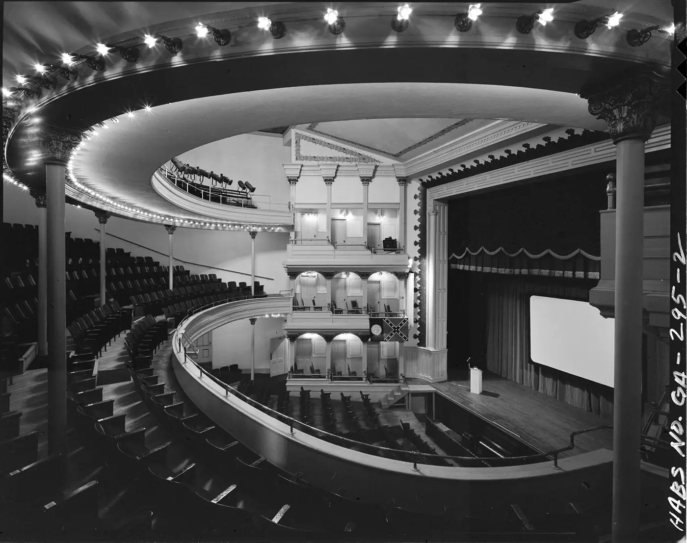 Black-and-white photograph of the Springer Opera House auditorium, with curved balconies and a proscenium stage