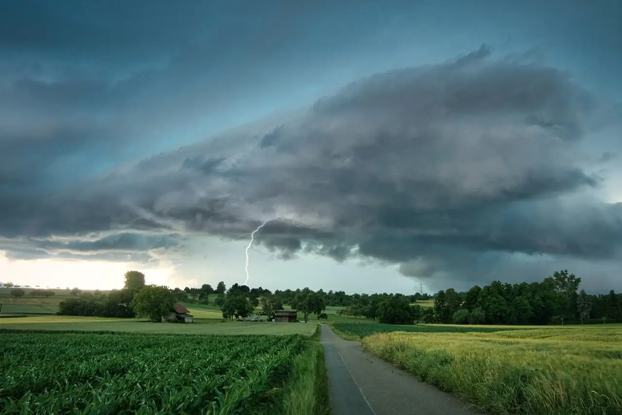 A storm front and lightning over fields